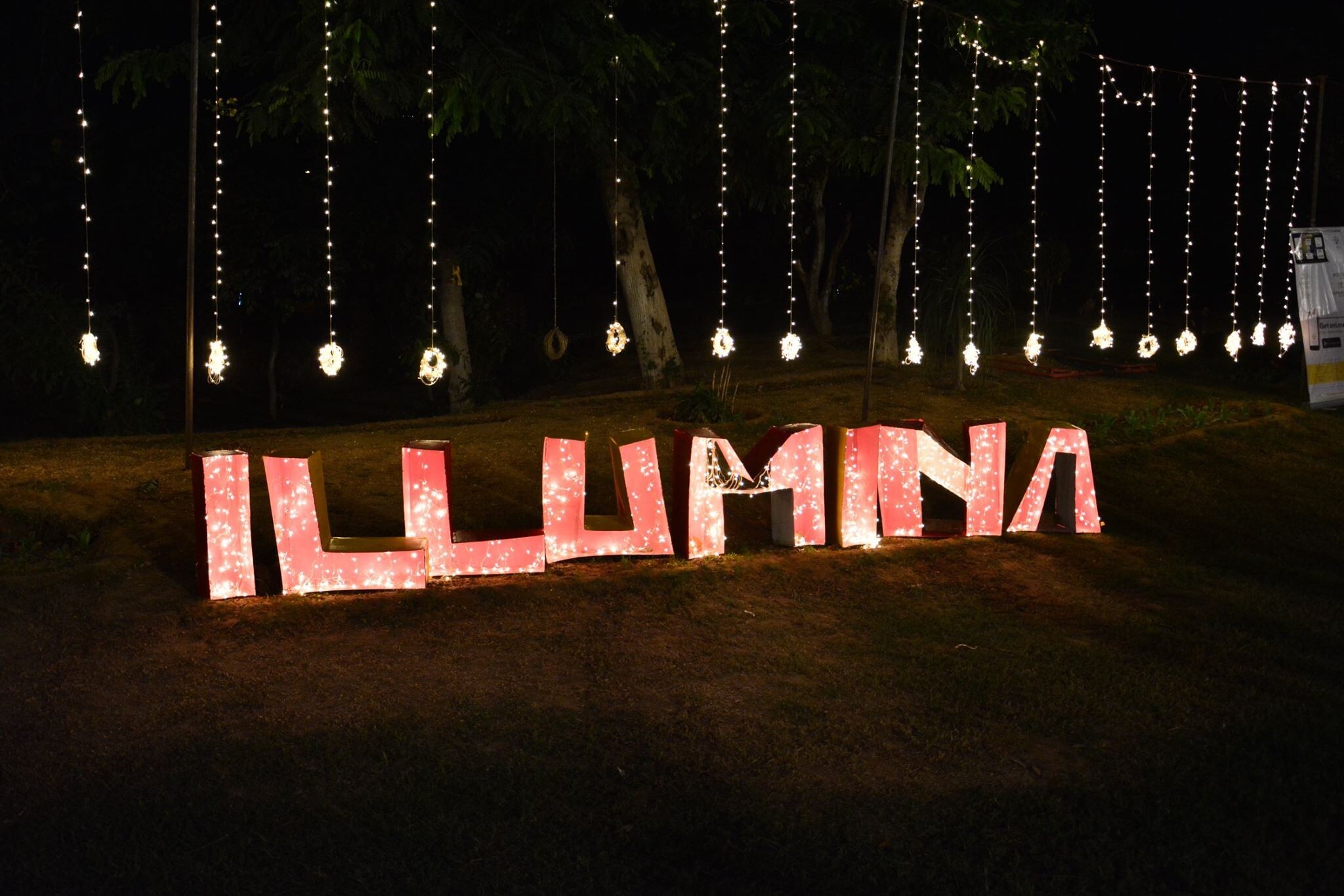 Illumina fest's cut-out being displayed with lights at night in MDI