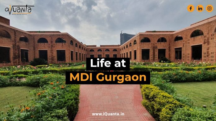 MDI Gurgaon Campus Photo with buildings in the back and garden in the front